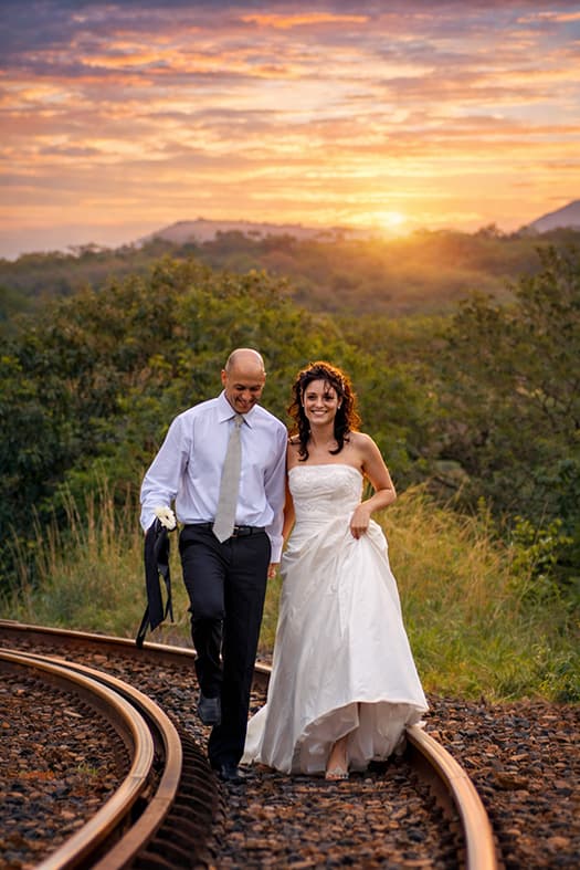 Bride and groom along the railway tracks